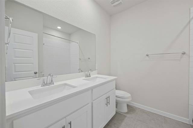 bathroom with vanity, a shower, tile patterned floors, and toilet