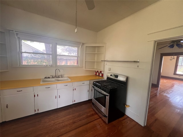 kitchen featuring dark hardwood / wood-style floors, sink, ceiling fan, and stainless steel gas range