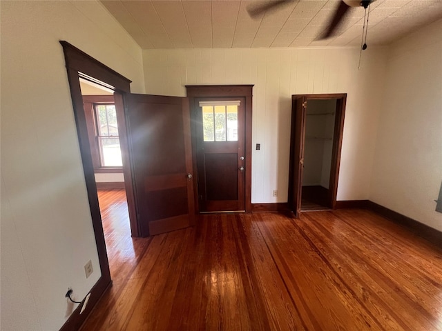 interior space with ceiling fan and wood-type flooring