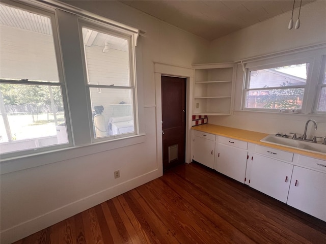 kitchen with white cabinets, dark hardwood / wood-style floors, and a healthy amount of sunlight