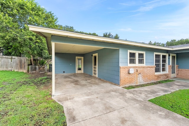 single story home with a front lawn and a carport