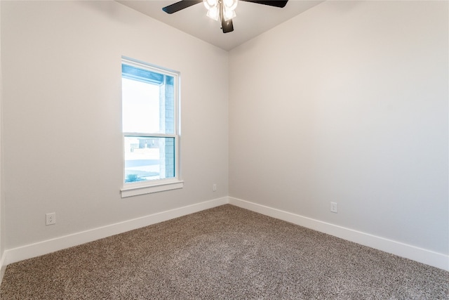 carpeted spare room featuring ceiling fan