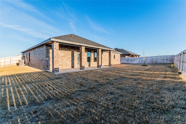 back of house featuring a yard and a patio area