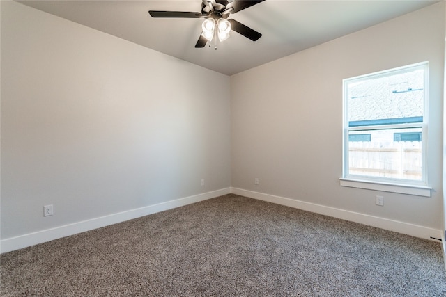 carpeted spare room featuring ceiling fan