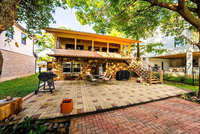 rear view of house with a patio and ceiling fan