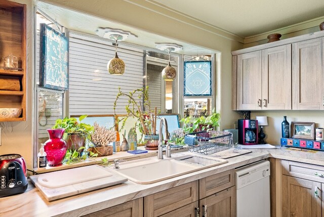 kitchen with light brown cabinets, dishwasher, decorative light fixtures, ornamental molding, and sink