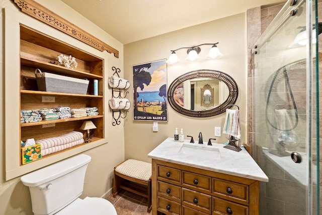 bathroom with a shower with door, toilet, and vanity