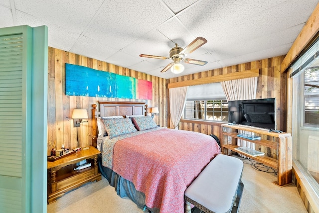 bedroom featuring multiple windows, light carpet, and ceiling fan