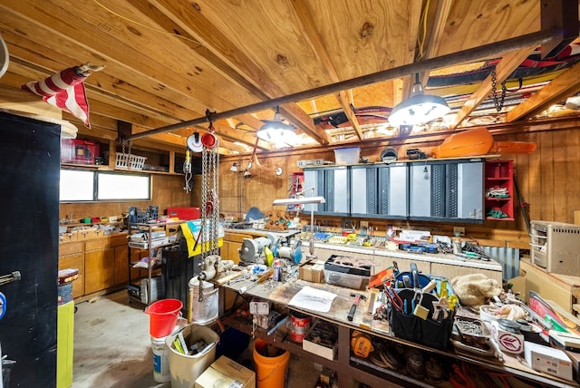 misc room with a workshop area and wooden walls