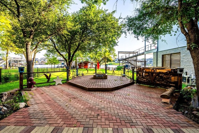 view of patio / terrace featuring a wooden deck and an outdoor fire pit