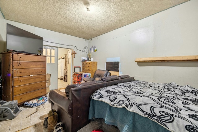 bedroom with a textured ceiling and tile patterned floors