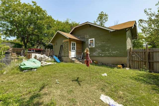 rear view of house with a yard