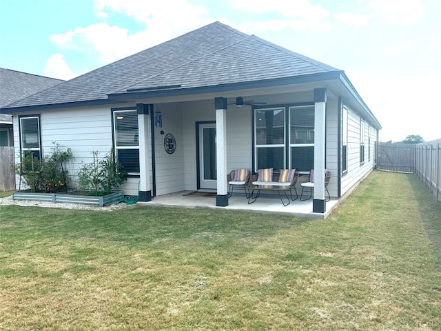 rear view of house with a patio area, a yard, and ceiling fan