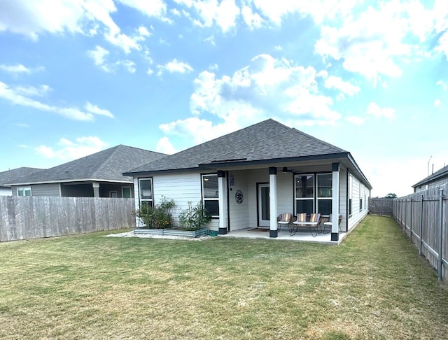 back of house featuring a patio and a lawn