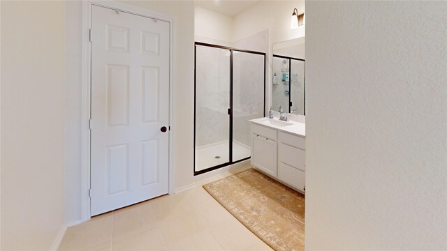 bathroom with walk in shower, tile patterned floors, and vanity