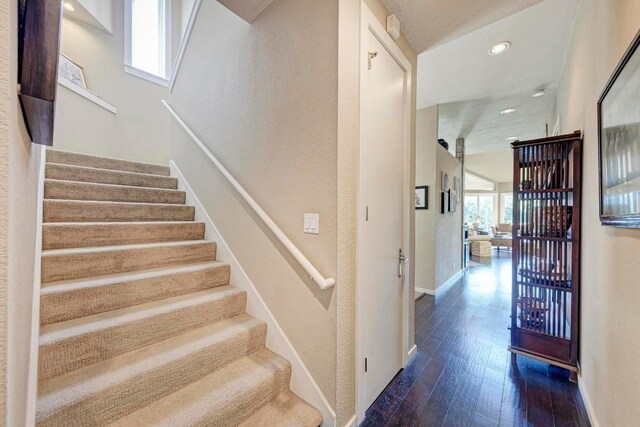 stairway with hardwood / wood-style flooring