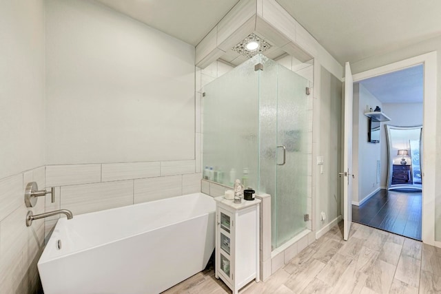 bathroom with shower with separate bathtub