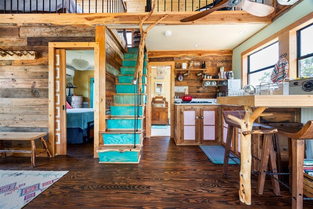 9000 Bear Creek Dr, Austin, TX 78737 - kitchen with wood walls and dark wood finished floors