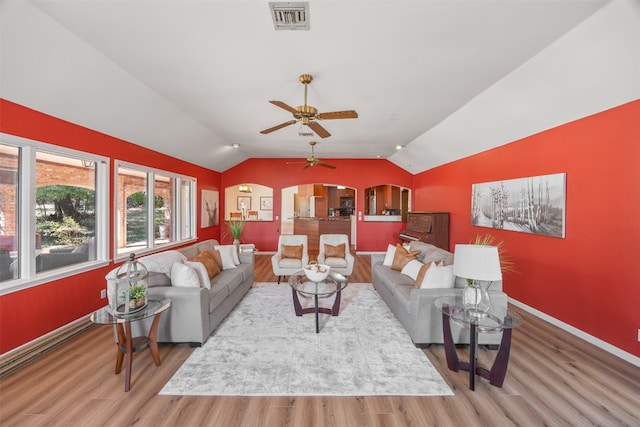 living room with hardwood / wood-style flooring, vaulted ceiling, and ceiling fan