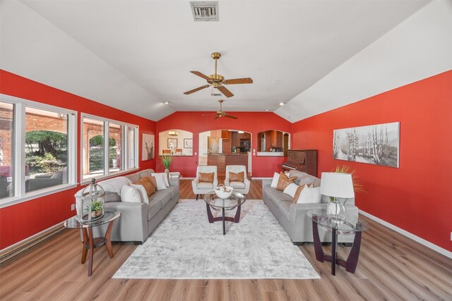 9000 Bear Creek Dr, Austin, TX 78737 - living room with wood finished floors, lofted ceiling, arched walkways, baseboards, and a ceiling fan
