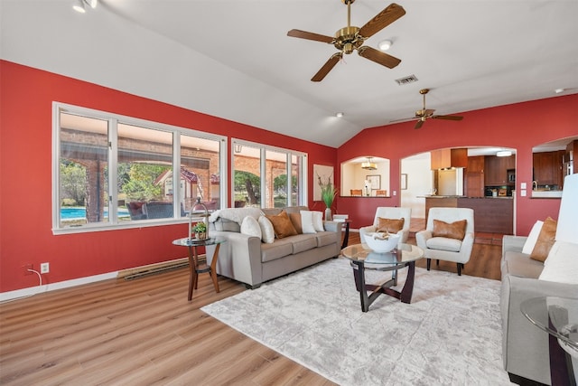 living room featuring lofted ceiling and light hardwood / wood-style floors