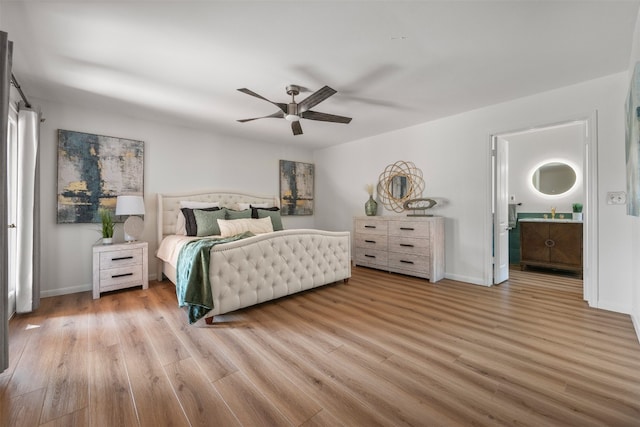 bedroom with light hardwood / wood-style flooring, ceiling fan, and ensuite bathroom