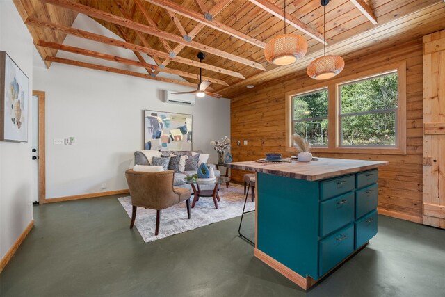 9000 Bear Creek Dr, Austin, TX 78737 - kitchen featuring wooden ceiling, butcher block counters, a wall mounted AC, concrete floors, and wooden walls