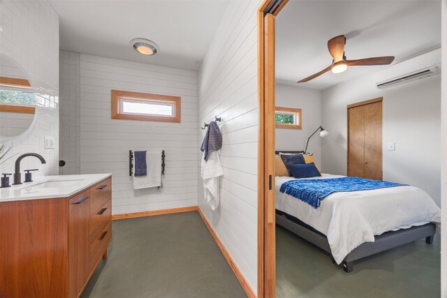 9000 Bear Creek Dr, Austin, TX 78737 - bedroom with a wall mounted air conditioner, a sink, wood walls, concrete flooring, and a ceiling fan