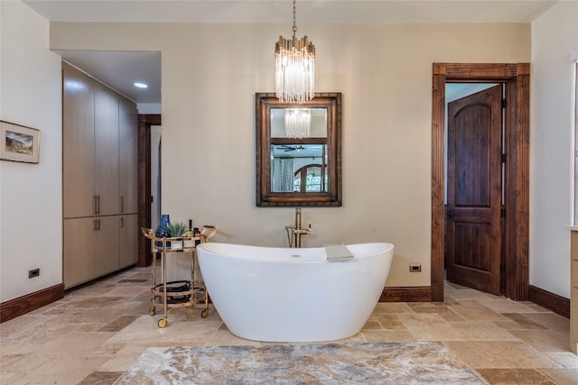 bathroom with tile patterned floors and an inviting chandelier