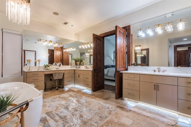 bathroom with a tub to relax in, tile patterned floors, and vanity