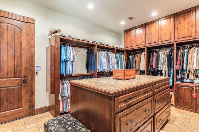 walk in closet with light tile patterned floors