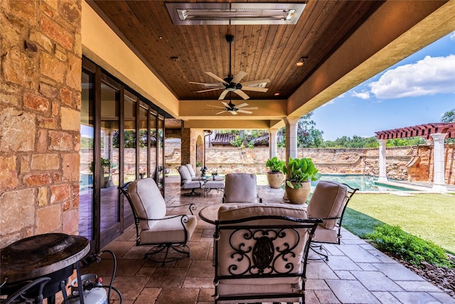 view of patio / terrace featuring ceiling fan and a fenced in pool