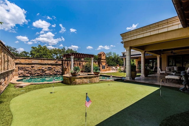 view of yard with ceiling fan, a fenced in pool, and a patio area