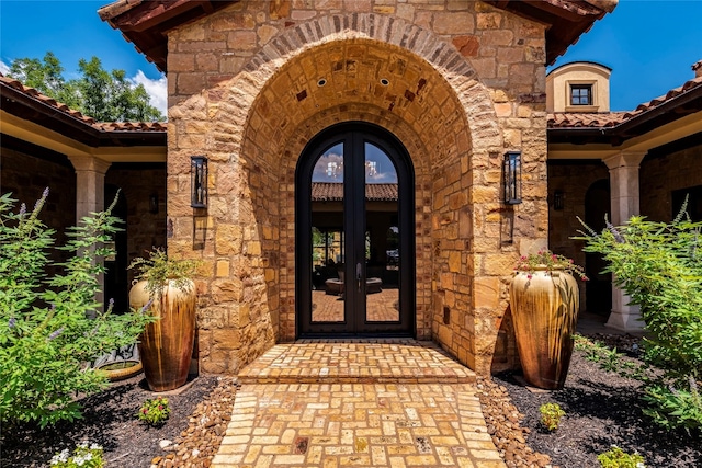 view of exterior entry featuring french doors