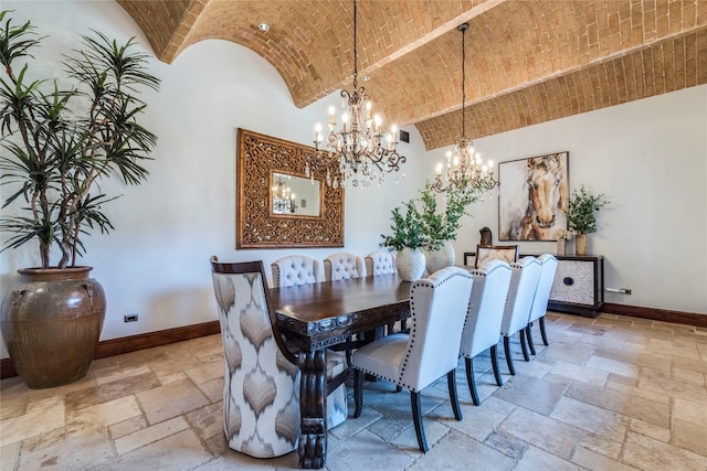 dining area featuring light tile patterned flooring, brick ceiling, an inviting chandelier, and a towering ceiling