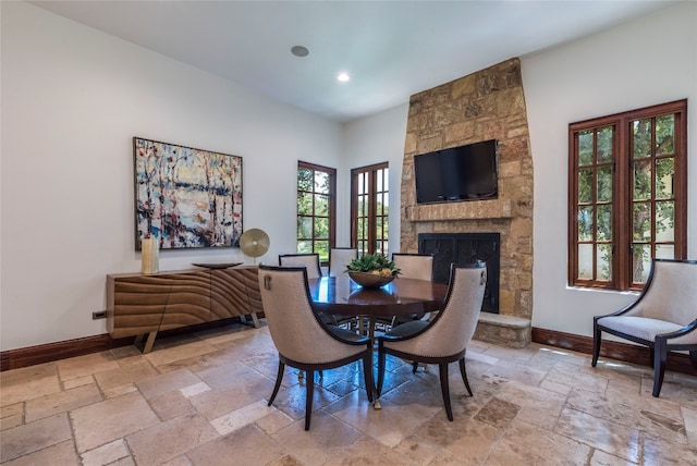 dining room with a fireplace and tile patterned flooring