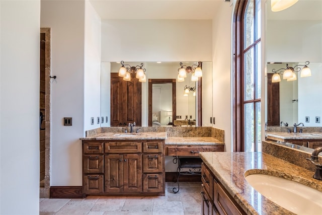 bathroom featuring double sink vanity, tile patterned floors, and plenty of natural light