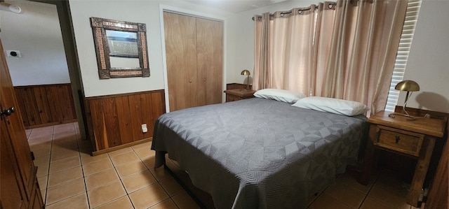 tiled bedroom with a closet