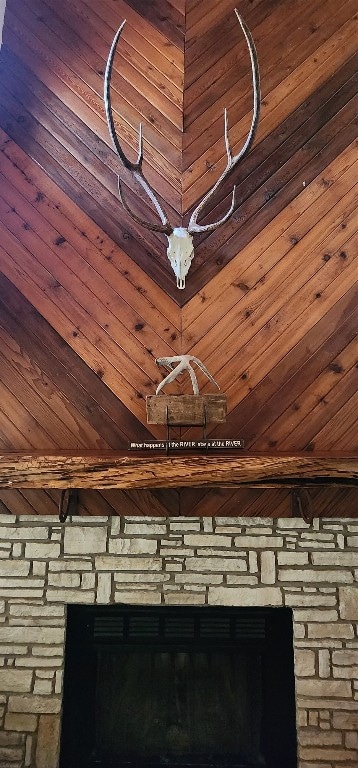 interior details featuring a stone fireplace