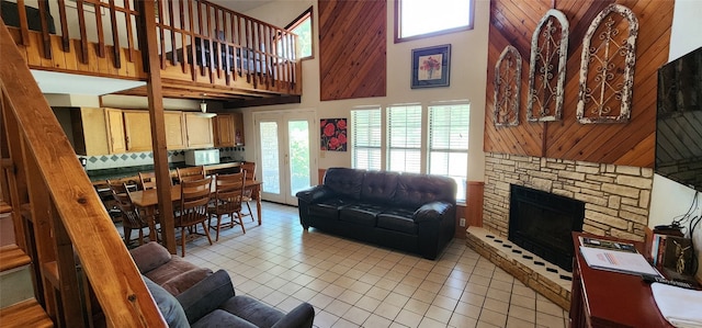 tiled living room with a fireplace and a high ceiling