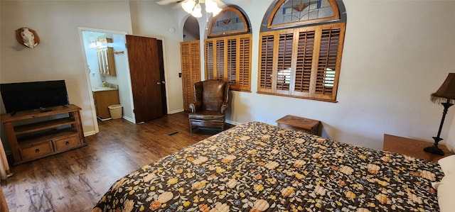 bedroom with connected bathroom, ceiling fan, and hardwood / wood-style floors