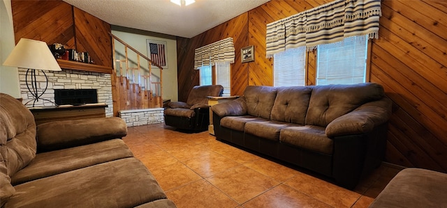 living room with lofted ceiling, wood walls, a textured ceiling, and tile patterned flooring