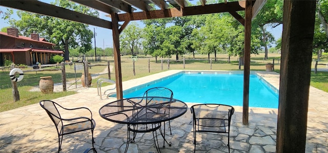 view of pool with a patio and a yard