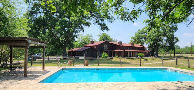 view of swimming pool featuring a pergola, a lawn, and a patio area