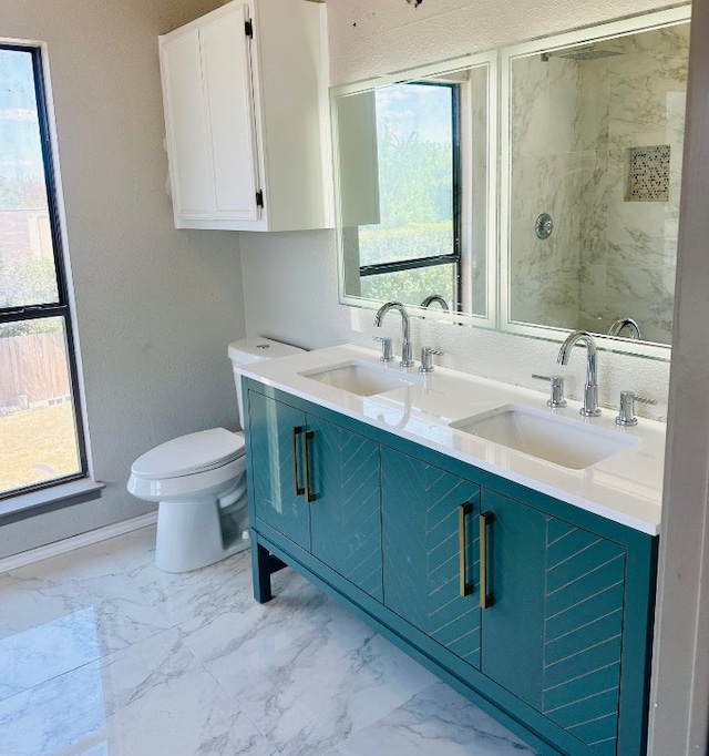 bathroom with a wealth of natural light, toilet, double vanity, and tile patterned flooring