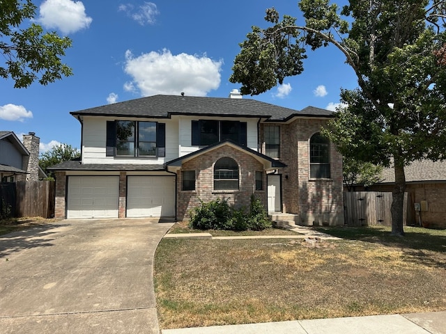 view of front of house with a front yard and a garage