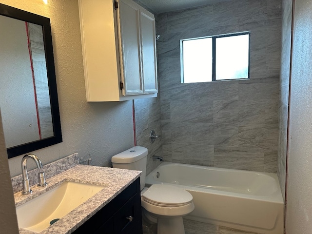 full bathroom with tiled shower / bath, vanity, and toilet