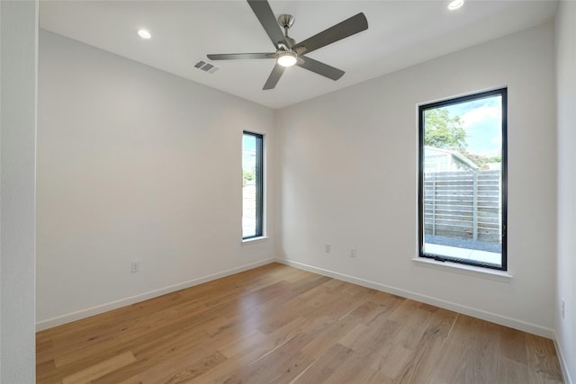 unfurnished room featuring ceiling fan, plenty of natural light, and light hardwood / wood-style floors