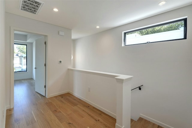 hallway with light hardwood / wood-style flooring