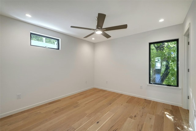 spare room with ceiling fan and light wood-type flooring